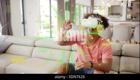 Using man wearing white VR headset manipulating green AR hologram over sofa in living room Stock Photo