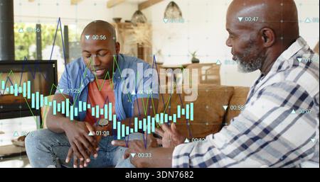 Talking two men, blue overshirt and plaid shirt, discussing financial overlays in living room Stock Photo