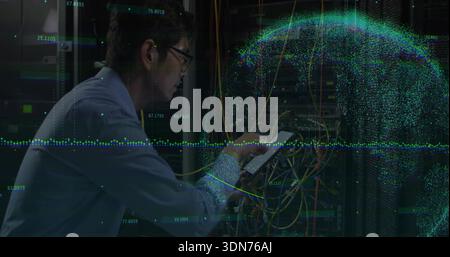 Inspecting tech in blue shirt checking data center racks patch cables and tablet with data overlay Stock Photo