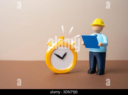 A civil engineer with blue drawings and a stopwatch. Construction and engineering deadlines. Project control shows time management, budget focus and o Stock Photo