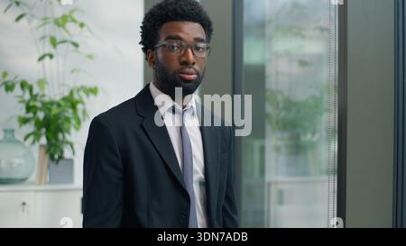 Hesitate thoughtful African American man business male entrepreneur businessman thinking idea startup corporate solution serious look at window Stock Photo
