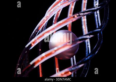 Futuristic chrome cage with a luminous orb on a black background. Ideal for sci-fi book covers, cinematic backgrounds, virtual reality concepts, and h Stock Photo
