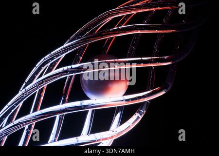 Abstract 3D render of a glowing sphere trapped in a metallic chrome lattice. Perfect for themes of core energy, nuclear fusion, advanced technology, a Stock Photo