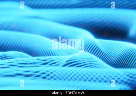 Digital landscape with neon blue undulating waves and a structured grid. A cinematic backdrop for virtual reality, cyberspace explorations, and advanc Stock Photo
