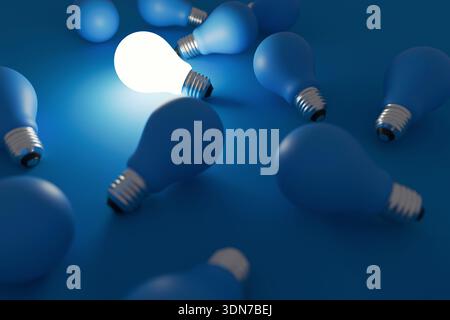 Glowing light bulb surrounded by many dark matte bulbs on a deep blue background. Concept of a unique bright idea, standing out from the crowd, indivi Stock Photo