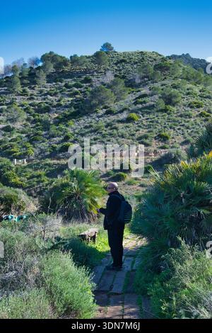Man walking through the mountains Stock Photo