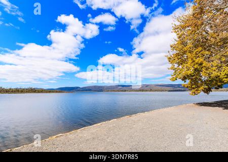 Lake Wartook reservoir landscape with rolling hills and dramatic clouds ...