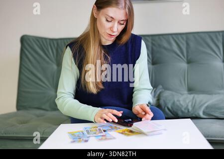 Tarot cards spread analyzed by AI technology on mobile phone Stock Photo