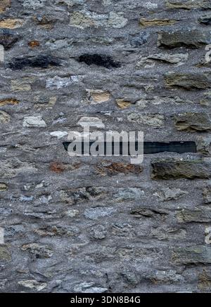 Grungy stone masonry forming a rough background surface. Stock Photo