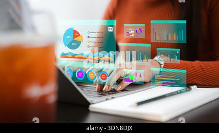 Asian businesswoman analyzing financial data with virtual dashboard on laptop. Concept of digital marketing, big data analytics, technology innovation Stock Photo