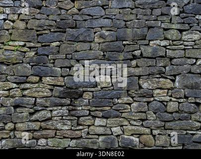 Moody Stone Facade Rough Texture Historic backdrop with black staining Stock Photo