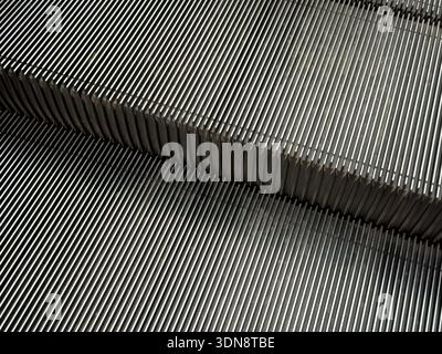 Close-up view of shiny metallic escalator steps showing intricate parallel grooves, emphasizing urban convenience, upward mobility, and mechanical pre Stock Photo