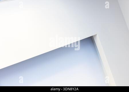 A clean, minimalist abstract composition featuring white and blue tones, diagonal lines, and sharp architectural panels. Evokes calm, modern space and Stock Photo