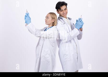 Two doctors in white coats holding test tubes in studio Stock Photo