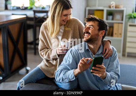 Multicultural couple working remotely, planning finances and investments online. Digital lifestyle Stock Photo