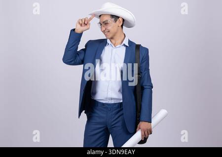 Man in blue suit and cowboy hat adjusting his hat Stock Photo