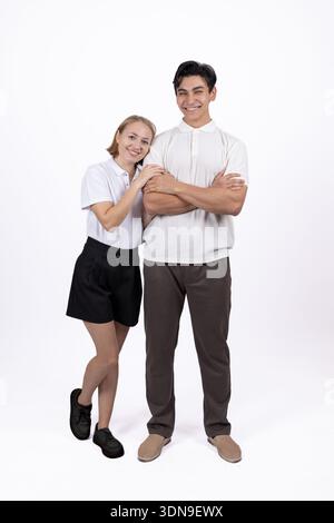 Young man and woman standing together in white shirts Stock Photo