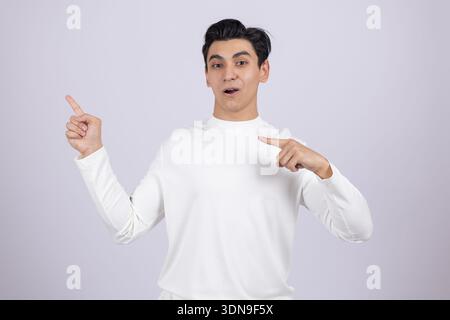Young guy pointing fingers at himself in studio Stock Photo