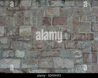 Irregular natural stone masonry with varying colors, textures and joints. Suitable for backgrounds and text spaces Stock Photo