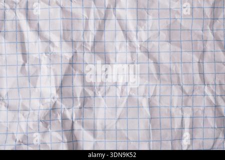White crumpled graph paper showing blue lines and textured surface Stock Photo
