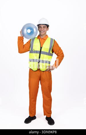 Man in work uniform shouting through a megaphone Stock Photo