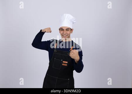 Happy chef in white uniform flexing his muscles Stock Photo