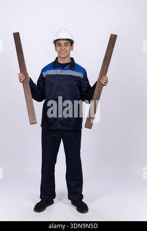Man in work uniform holding large paper blueprints Stock Photo