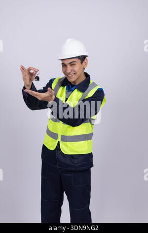 Worker in safety helmet using a digital tablet Stock Photo