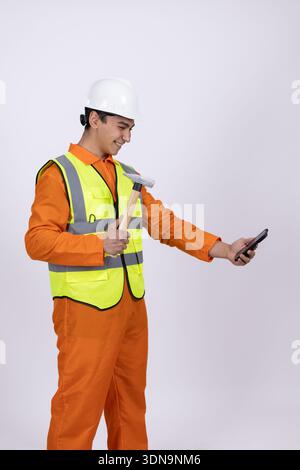 Construction worker using smartphone on white background Stock Photo