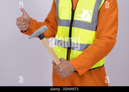 Construction worker holding a hammer in studio Stock Photo