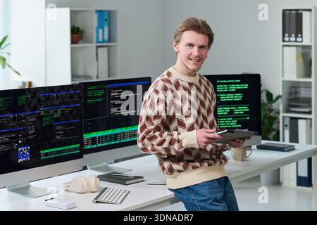 Young Man Using Digital Tablet While Working in Office Stock Photo