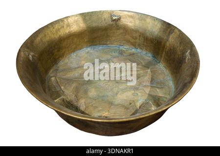 Large ceremonial bronze basin with repoussé decoration of central Asian landscape, featuring a central mountains, stylised waves, and cloud motifs, with small applied animal figures (horse, yak, etc.)along the inner rim. Such basins were commonly used in Central Asian and Himalayan regions for ritual, ceremonial, or ablutionary purposes. Stock Photo