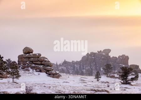 A midwinter snowy sunrise at the rock formations of Vedauwoo in southeastern Wyoming.  The popular national forest area off I-80 near Laramie, is know Stock Photo