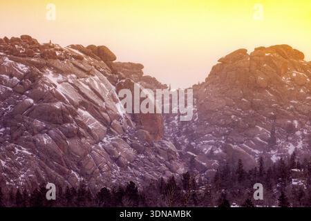 A midwinter snowy sunrise at the rock formations of Vedauwoo in southeastern Wyoming.  The popular national forest area off I-80 near Laramie, is know Stock Photo