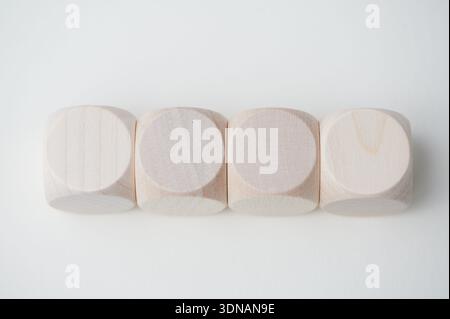 Four wooden blocks on a white background with a simple design. Stock Photo