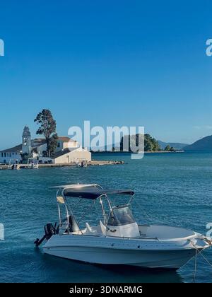 White Motorboat Moored Near Vlacherna Monastery in Corfu Greece Stock Photo
