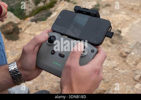 Man holding drone controller outdoors Stock Photo