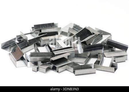 Paper clips from a stapler on an isolated white background Stock Photo