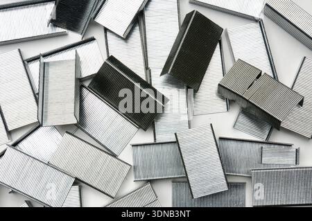 Paper clips from a stapler on an isolated white background Stock Photo