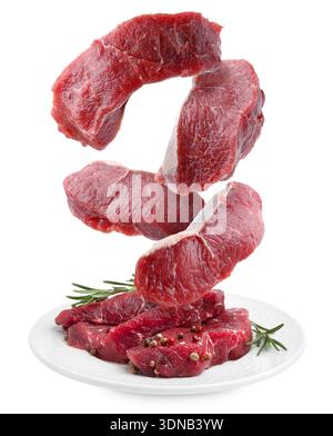 Fresh beef steaks falling on white background Stock Photo