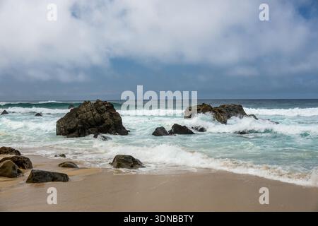 Boulders In The Surf Break Up Waves On A Stormy Day on Big Sur Coast Stock Photo