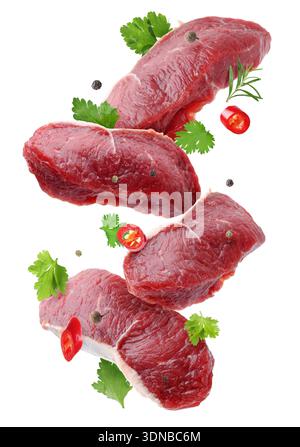 Fresh beef steaks falling on white background Stock Photo