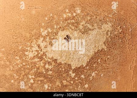 weathered plaster wall surface, damp staining with peeling orange paint and bubbling texture, grunge background and urban decay concept in closeup Stock Photo