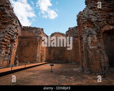 Interior scene of a ruined construction with brick walls and arches, illuminated by natural light. Useful for topics of history, architecture, archaeo Stock Photo