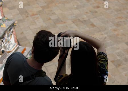 Tourist couple tourists taking a photograph with digital camera and exploring at Thai temple, high angle view Stock Photo