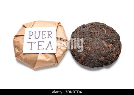 Dry pressed puer tea with sticky note on white background Stock Photo