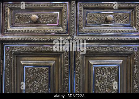 an old cupboard door carved with a pattern Stock Photo