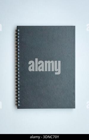 Black color book cover with side spiral ring. Isolated on white background. Copy space. Stock Photo