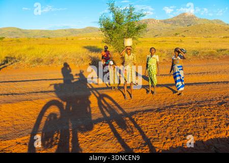 Madagascar, Anosy region, Ambalasoa, National Road 13 or RN13 which is a very damaged track, shadow of the KTM450 motorcycle and the children Stock Photo