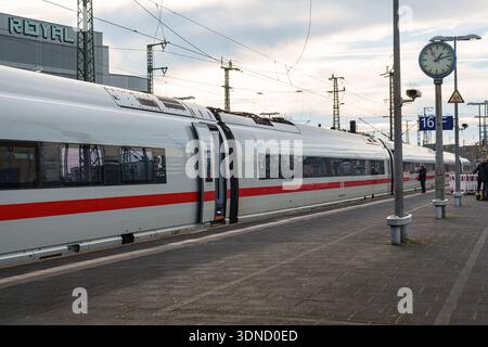 German ICE high-speed train waiting at Düsseldorf main train station platform with clock Stock Photo